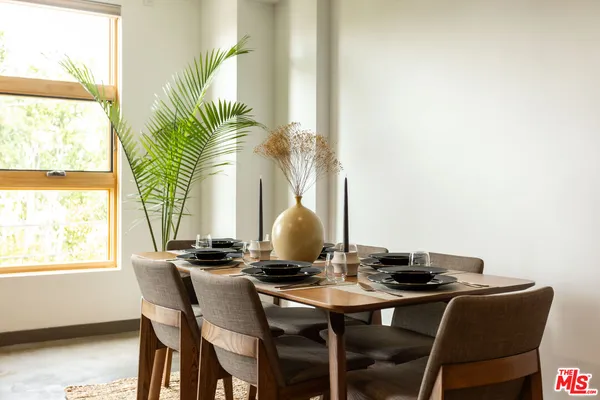 a dining room with furniture and a window
