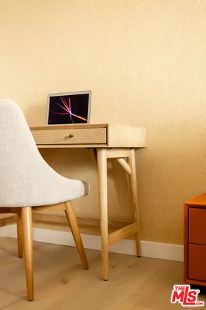 a living room with a table and a rug