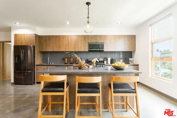 a kitchen with stainless steel appliances granite countertop a stove and a refrigerator