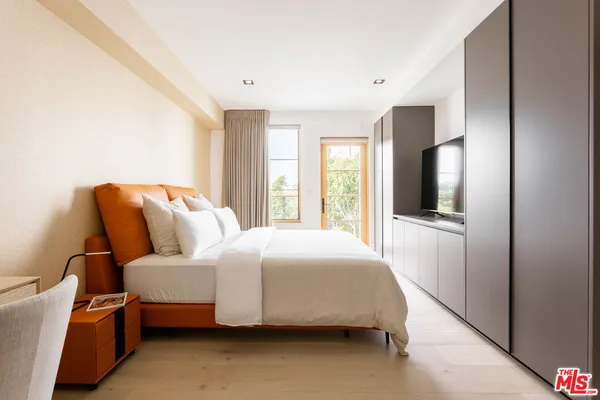 a bedroom with bed and window