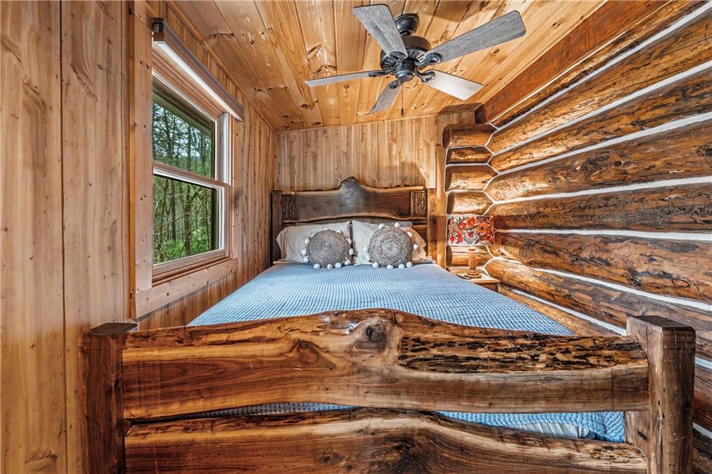 1790 Stanley Creek Road Cherry Log, GA 30522 - Photo 14 of 31 a bed sitting in a bedroom next to a window