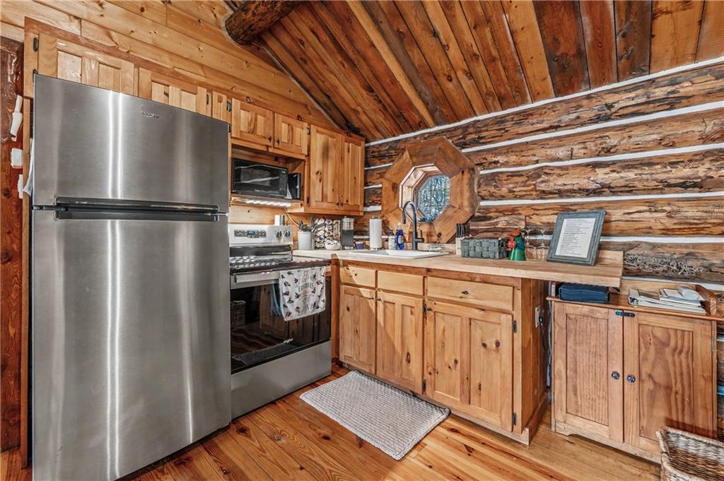 1790 Stanley Creek Road Cherry Log, GA 30522 - Photo 10 of 30 a kitchen with stainless steel appliances a refrigerator and a stove top oven