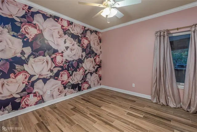 a view of a livingroom with wooden floor and a window