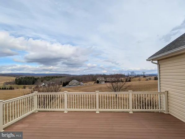 a large kitchen with kitchen island granite countertop a large window and stainless steel appliances