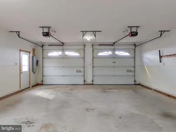 wooden floor fireplace and windows in an empty room