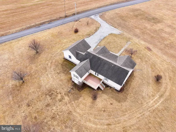 a view of a large house with a big yard and large tree