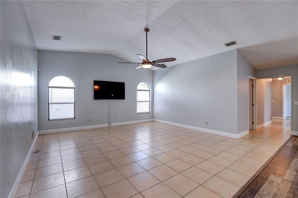 1418 Buckner Road Valrico, FL 33596 - Photo 21 of 37 a view of a livingroom with a chandelier fan and windows