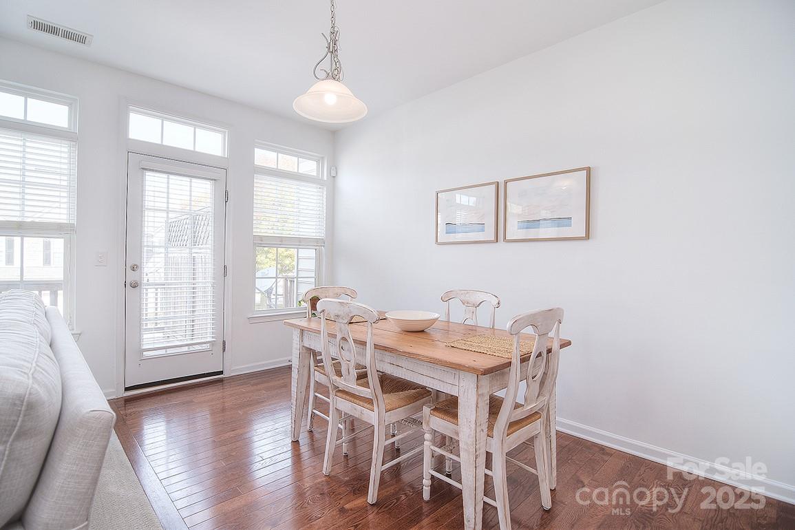 6134 Rockefeller Lane Charlotte, NC 28210 - Photo 14 of 47 a view of a dining room with furniture wooden floor and chandelier