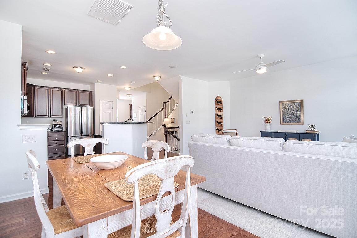 6134 Rockefeller Lane Charlotte, NC 28210 - Photo 16 of 47 a living room with kitchen island furniture and a wooden floor
