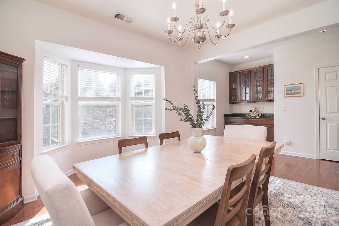 6134 Rockefeller Lane Charlotte, NC 28210 - Photo 19 of 47 a view of a dining room with furniture window and wooden floor