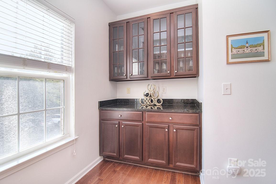 6134 Rockefeller Lane Charlotte, NC 28210 - Photo 20 of 47 a kitchen with stainless steel appliances granite countertop a sink and cabinets with wooden floor