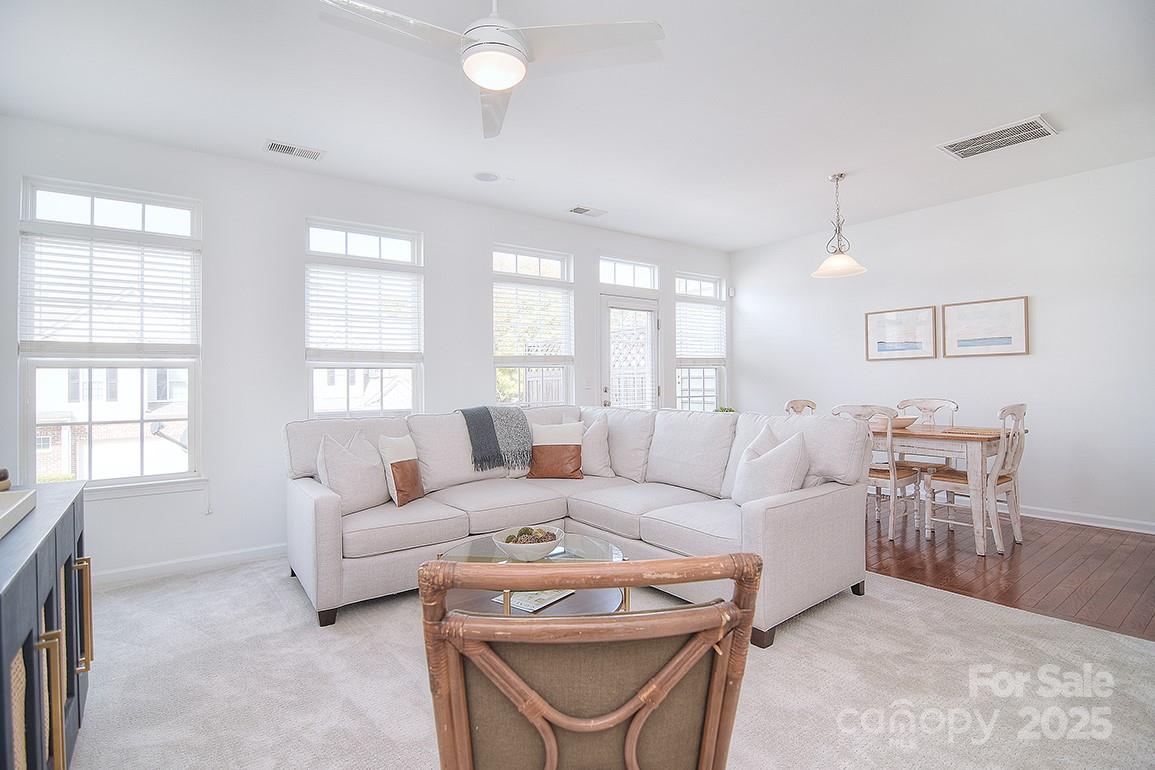 6134 Rockefeller Lane Charlotte, NC 28210 - Photo 22 of 47 a living room with furniture a large window and a table