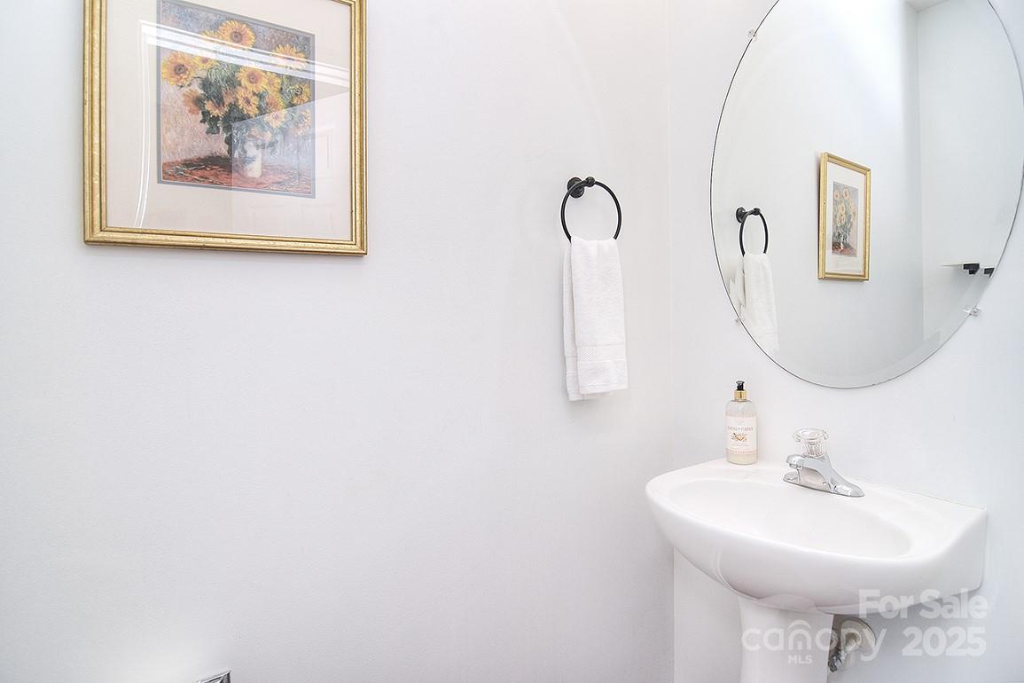 6134 Rockefeller Lane Charlotte, NC 28210 - Photo 25 of 47 a bathroom with a sink and a mirror