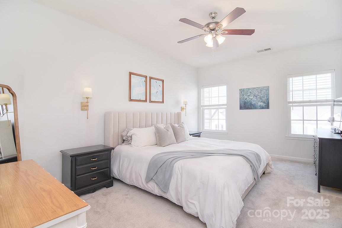 6134 Rockefeller Lane Charlotte, NC 28210 - Photo 30 of 47 a bedroom with a bed and a chandelier