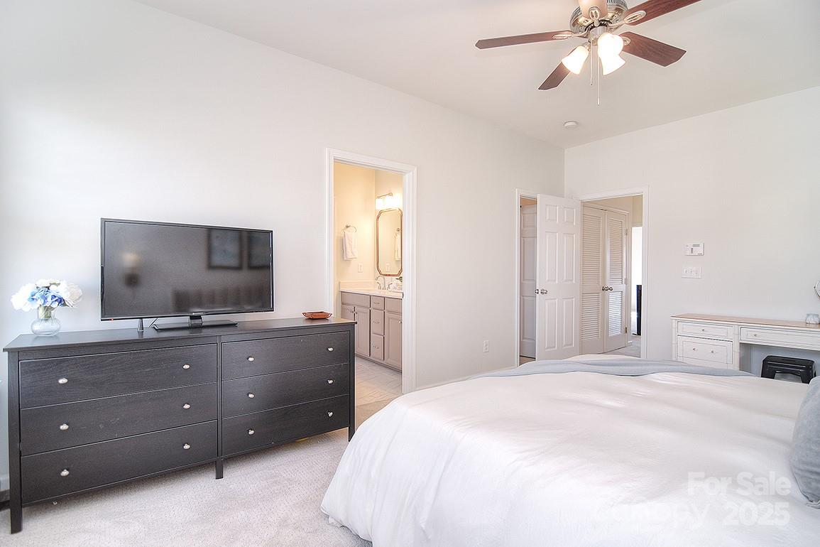 6134 Rockefeller Lane Charlotte, NC 28210 - Photo 32 of 47 a bedroom with a bed and a flat screen tv