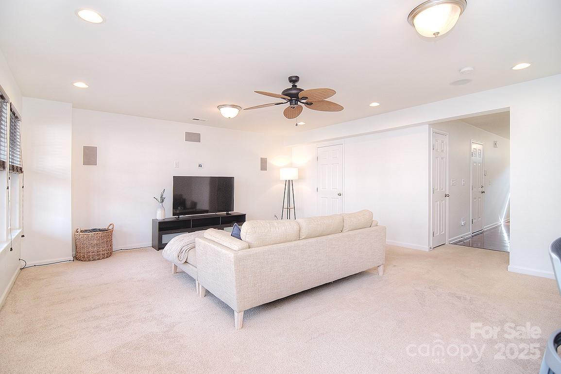 6134 Rockefeller Lane Charlotte, NC 28210 - Photo 5 of 47 a living room with furniture and a ceiling fan