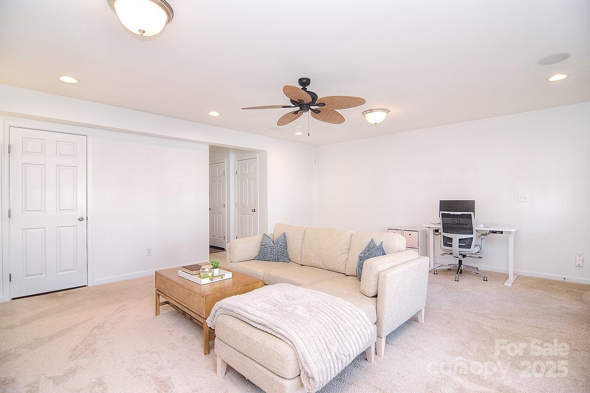 6134 Rockefeller Lane Charlotte, NC 28210 - Photo 6 of 47 a living room with furniture and a ceiling fan