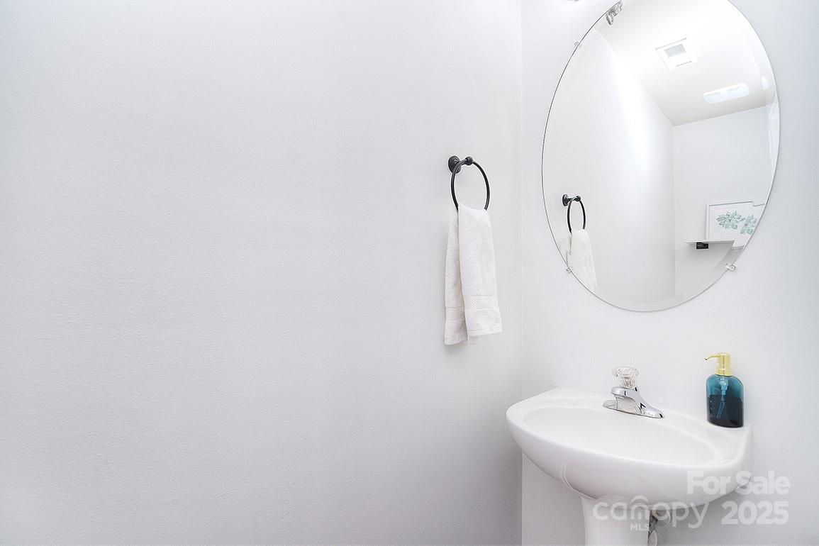 6134 Rockefeller Lane Charlotte, NC 28210 - Photo 8 of 47 a bathroom with a sink and a mirror