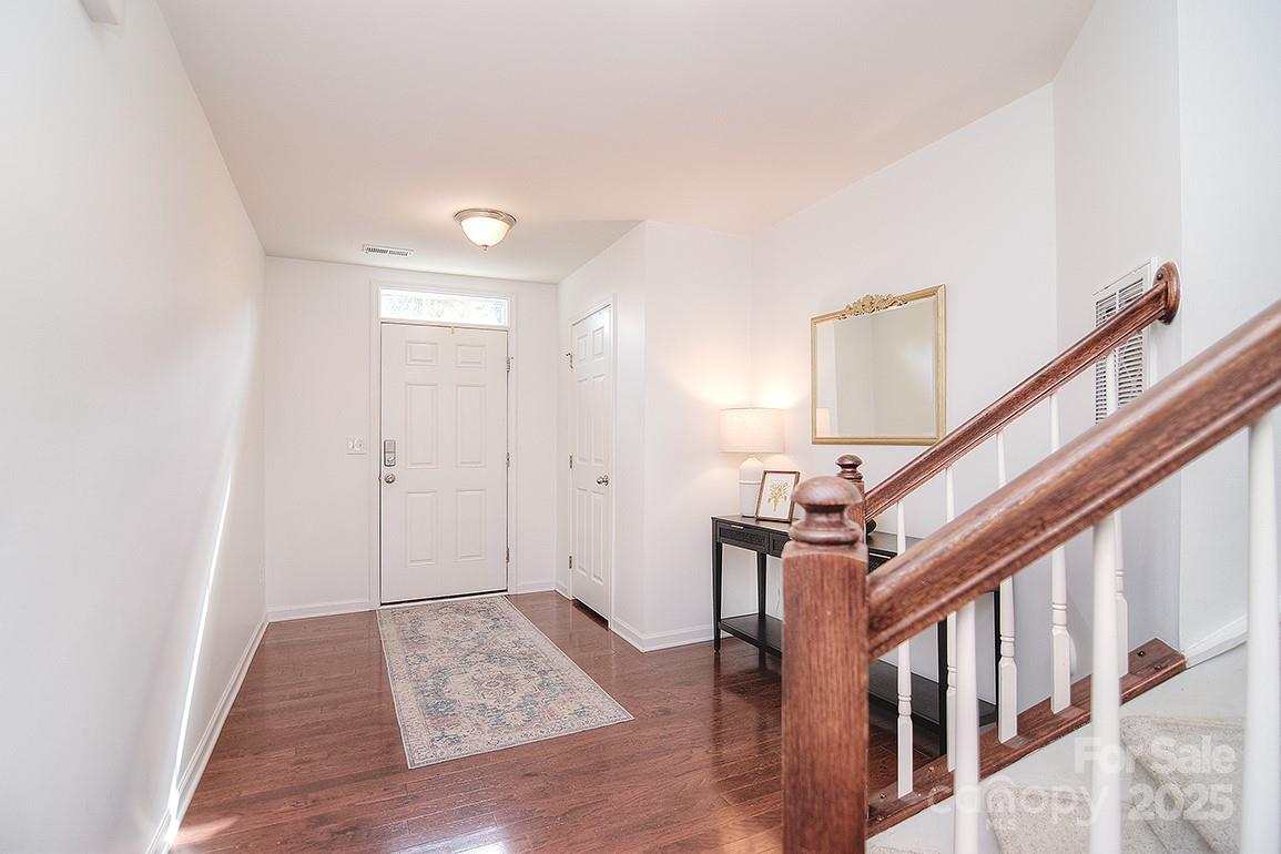 6134 Rockefeller Lane Charlotte, NC 28210 - Photo 9 of 47 a view of entryway and hall with wooden floor