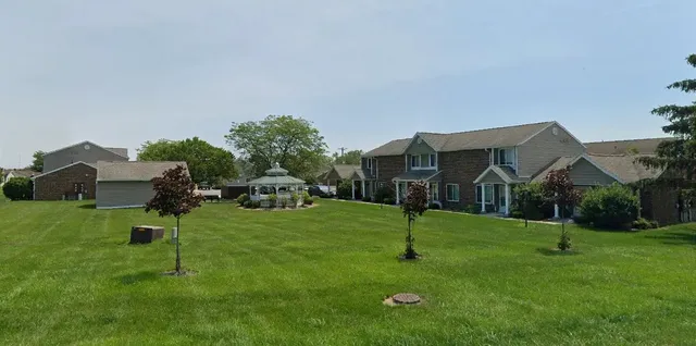a house view with a play ground in front of it