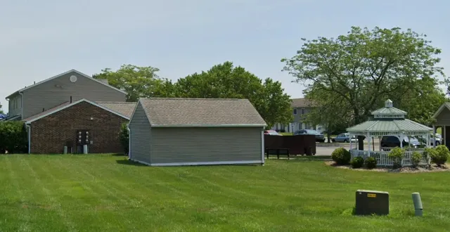 a view of a house with backyard and garden