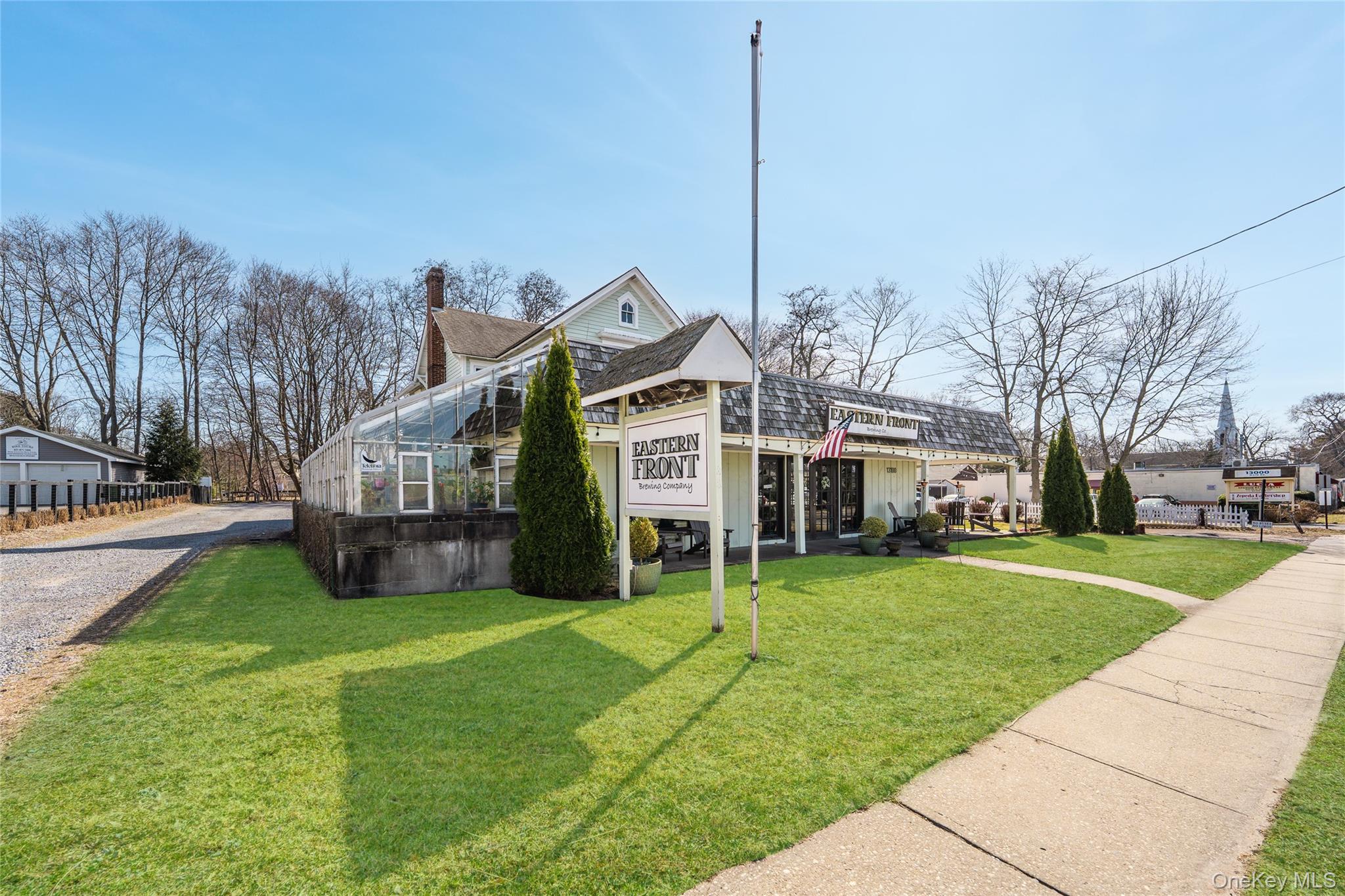 13100 Main Road Mattituck, NY 11952 - Photo 2 of 25 a front view of building with yard