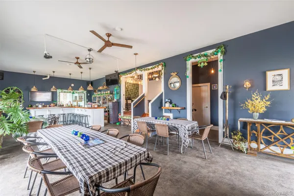 a dining room with furniture a rug and a large window
