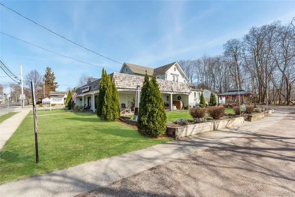 a view of a house with a yard porch and sitting area