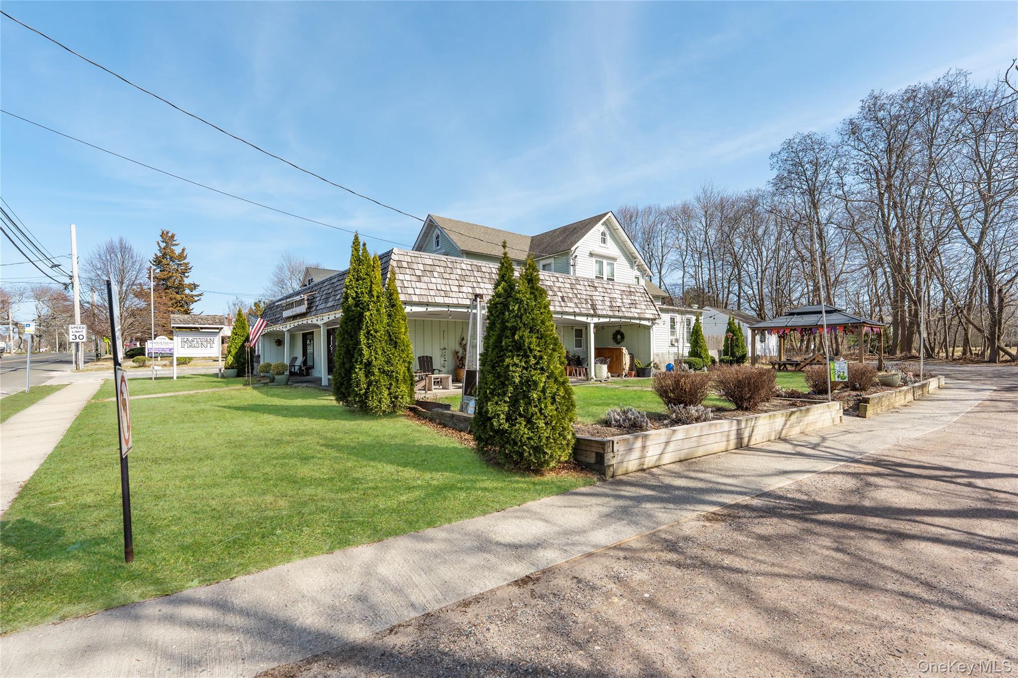 13100 Main Road Mattituck, NY 11952 - Photo 4 of 25 a view of a house with a yard porch and sitting area
