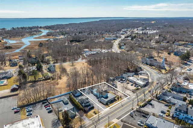 an aerial view of a house with a lake