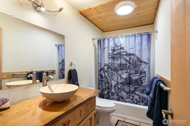 a view of bathroom with a toilet sink and a mirror