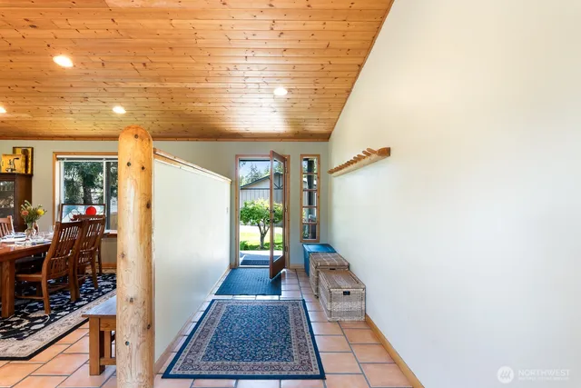 a view of hallway with furniture and a rug