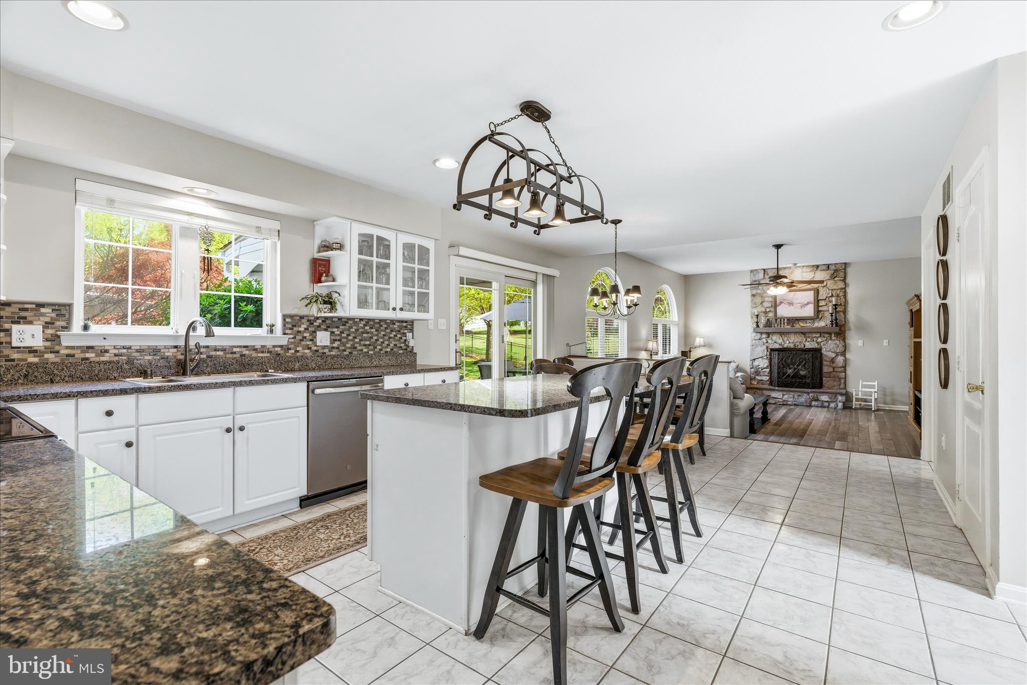 4114 Lomar Terrace Mount Airy, MD 21771 - Photo 22 of 91 a kitchen with stainless steel appliances granite countertop a sink a stove a dining table and chairs