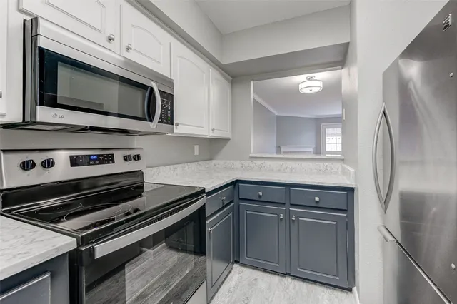 a kitchen with stainless steel appliances and cabinets