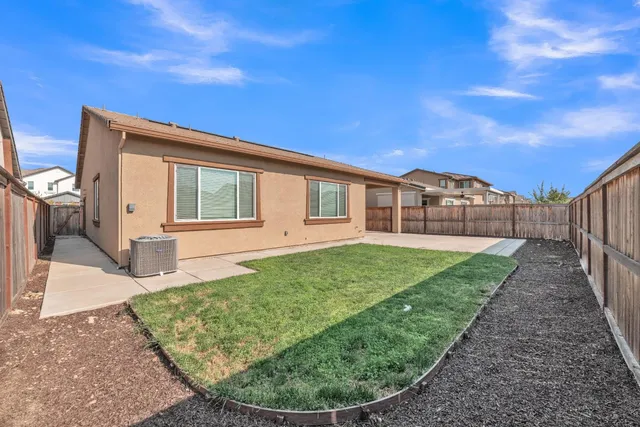 a view of a house with wooden fence