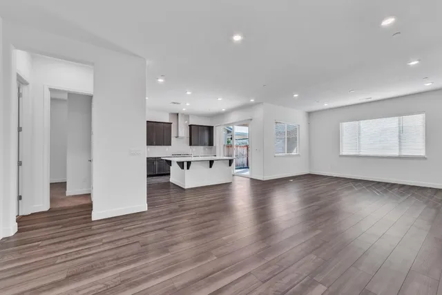 a view of kitchen with kitchen island and stainless steel appliances