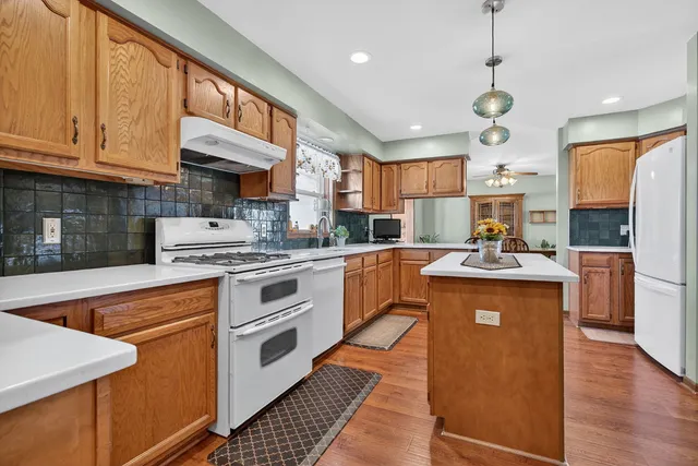 a dining room with furniture a window and wooden floor
