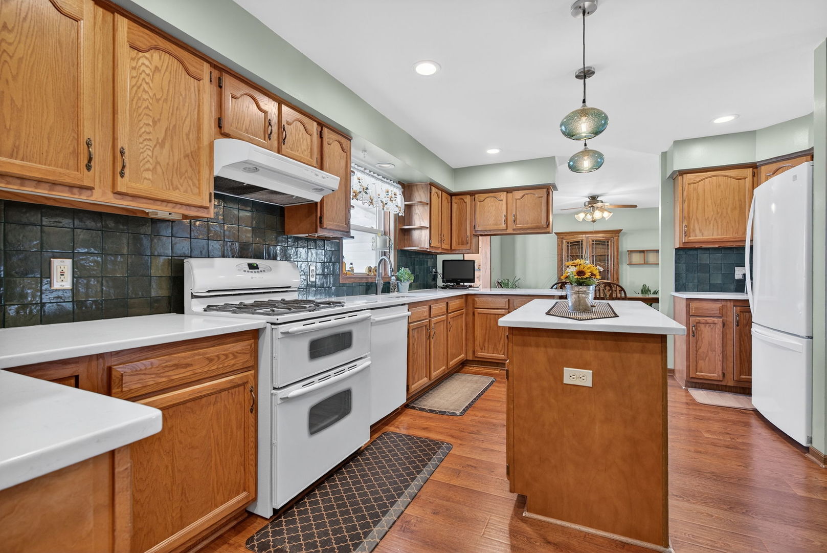 2420 North Dwight Road Morris, IL 60450 - Photo 11 of 38 a kitchen with stainless steel appliances granite countertop a refrigerator a stove top oven a sink dishwasher and white cabinets with wooden floor