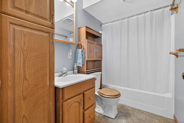 a living room with furniture ceiling fan and a window