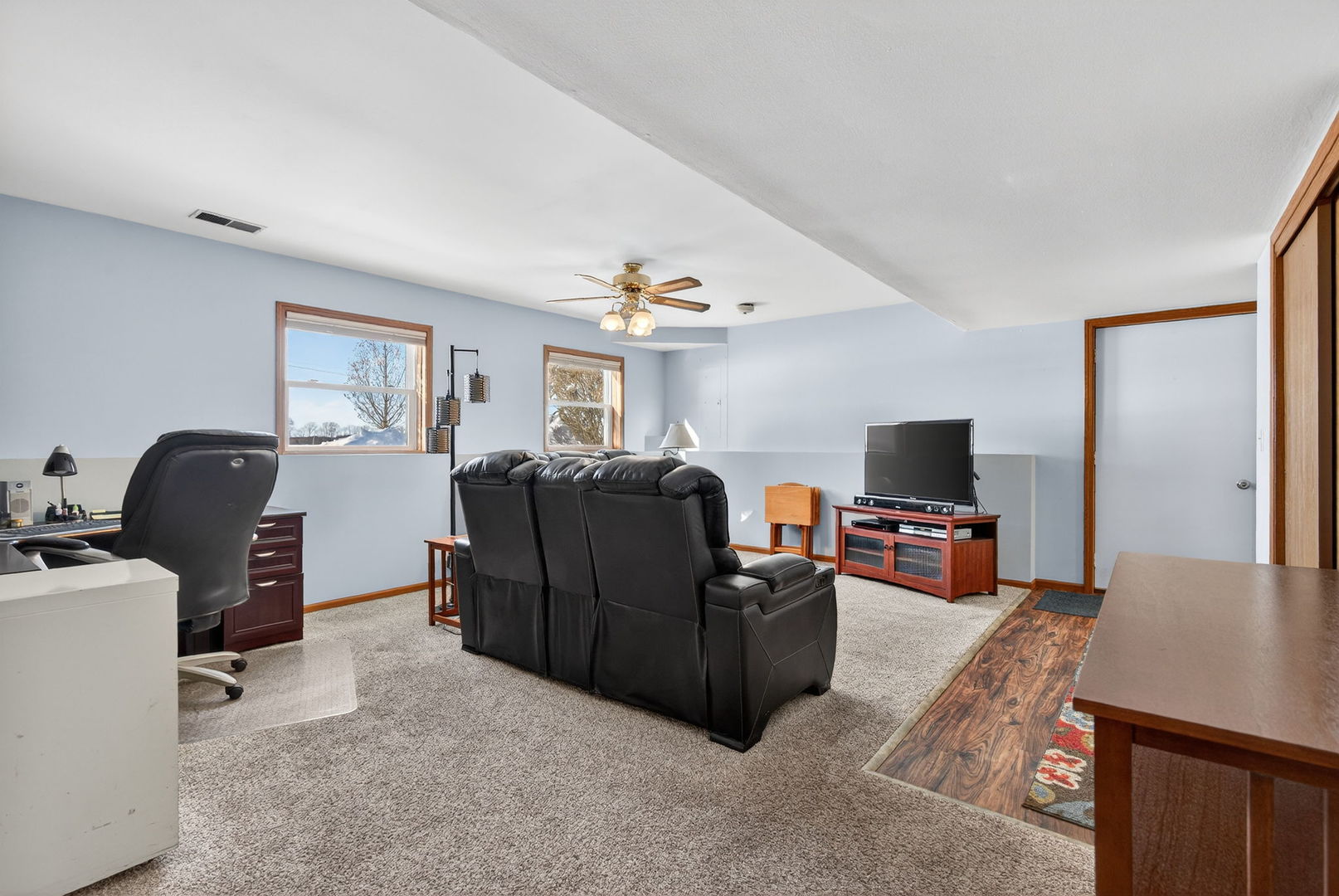 2420 North Dwight Road Morris, IL 60450 - Photo 24 of 38 a living room with furniture a flat screen tv and a refrigerator