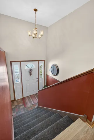a living room with furniture ceiling fan and a large window
