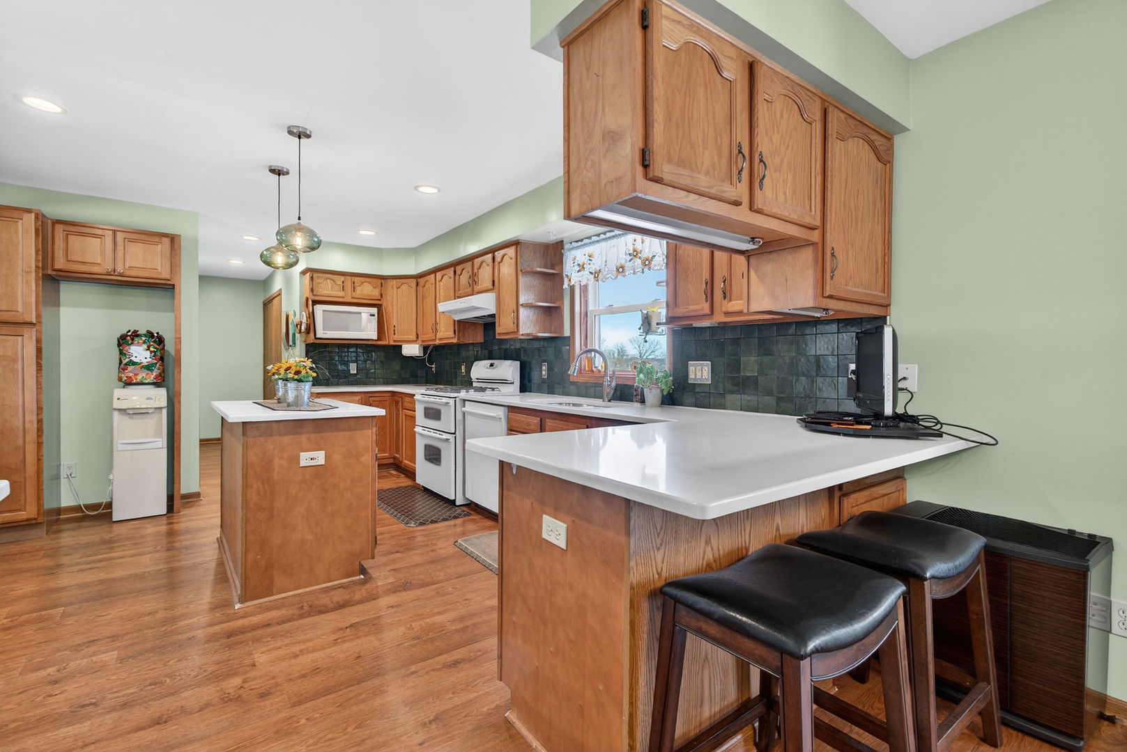 2420 North Dwight Road Morris, IL 60450 - Photo 7 of 38 a kitchen with stainless steel appliances granite countertop a refrigerator a sink dishwasher a stove and a dining table with wooden floor
