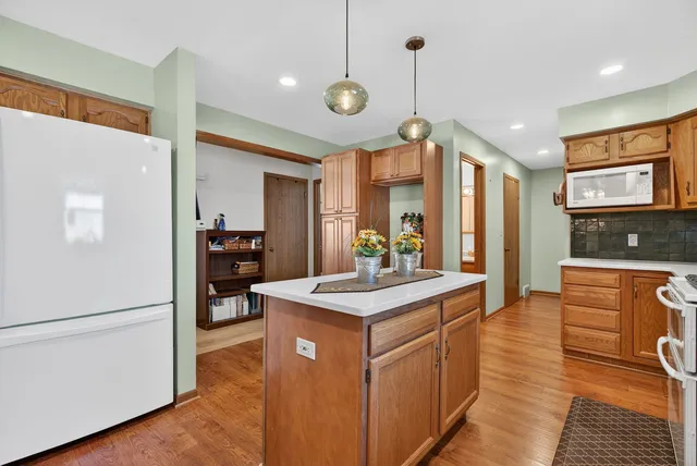 a kitchen with stove a sink and refrigerator