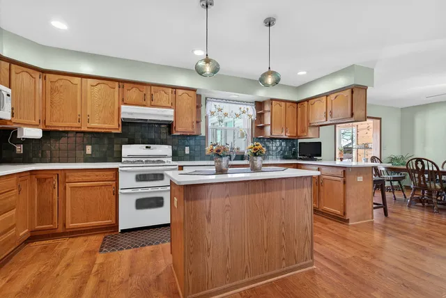 a kitchen with stainless steel appliances granite countertop a stove and a refrigerator