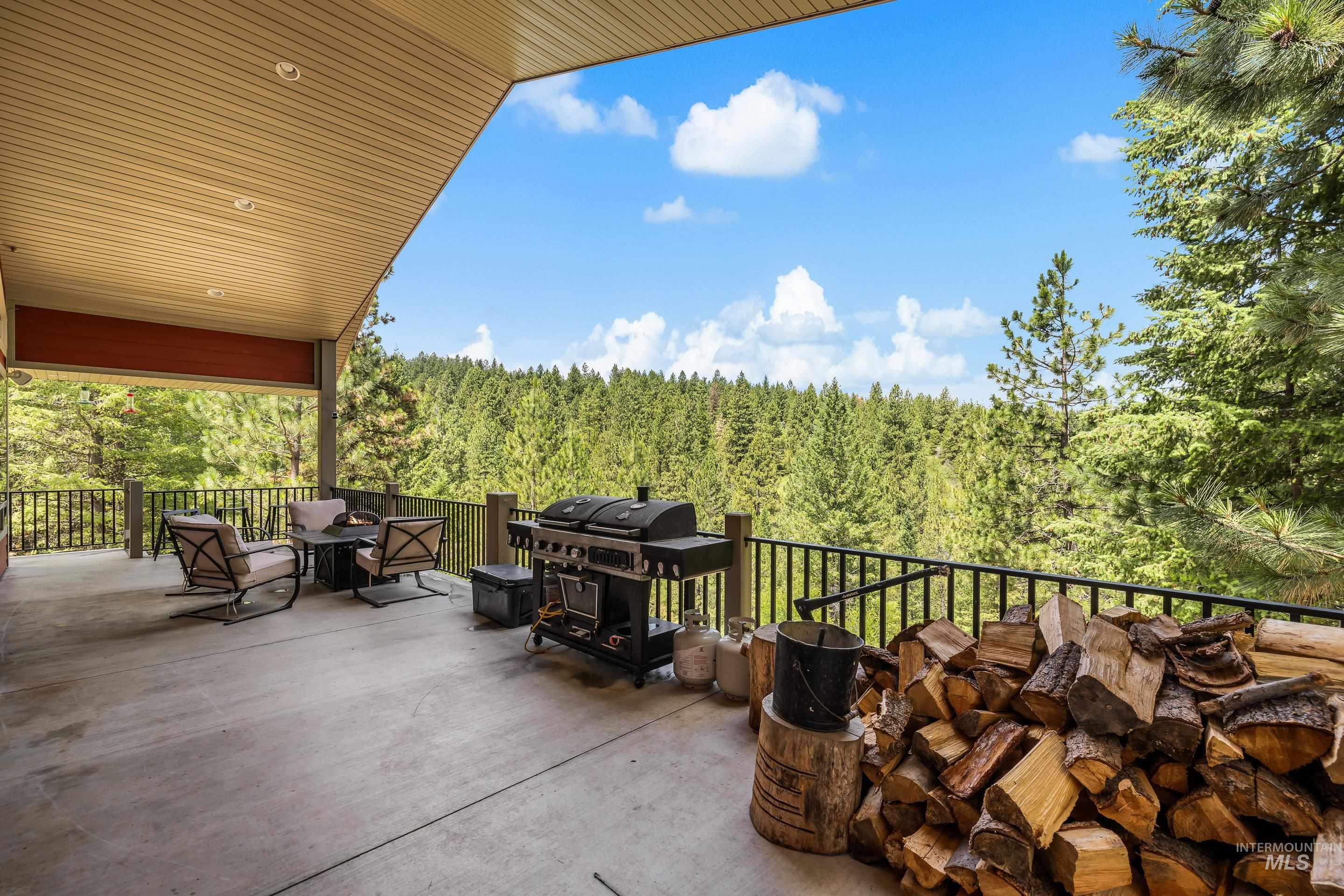 92 Cruickshank Road Horseshoe Bend, ID 83629 - Photo 43 of 50 Expansive covered outdoor patio featuring a concrete surface, black metal railing, and recessed ceiling lighting