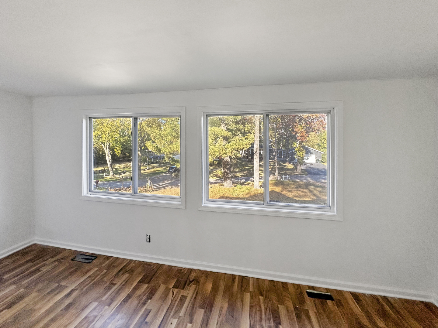 28611 Mall Road Ingleside, IL 60041 - Photo 7 of 7 a view of an empty room with wooden floor and a window