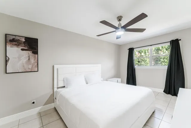 a bedroom with a large bed and a large window