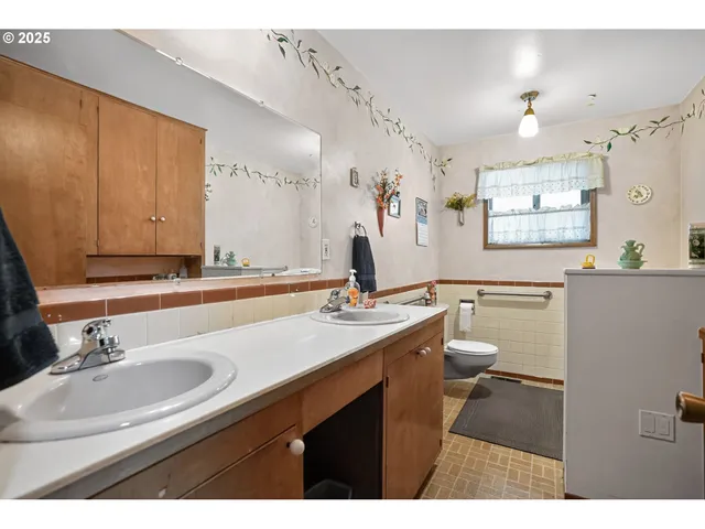 a bathroom with a sink mirror and toilet