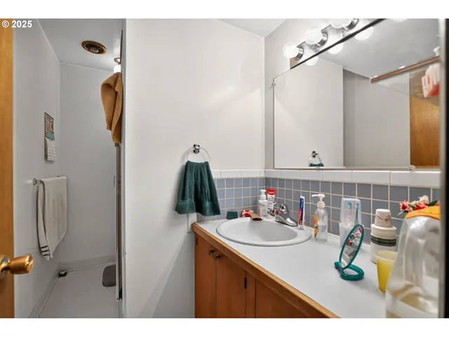 a bathroom with a sink vanity and mirror