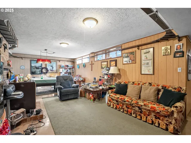 a living room with furniture a flat screen tv and a window
